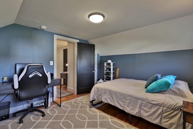 bedroom featuring wood-type flooring and lofted ceiling