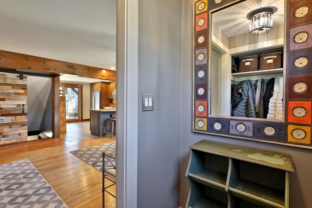 interior space with stainless steel fridge, hardwood / wood-style floors, and a barn door