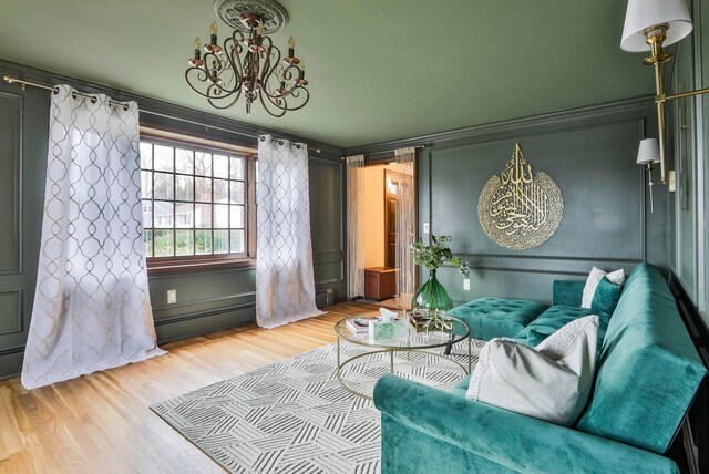 sitting room with crown molding, wood-type flooring, and baseboard heating