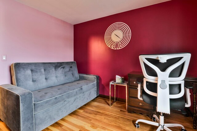 sitting room with wood-type flooring