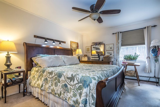 bedroom featuring ceiling fan, crown molding, and carpet floors