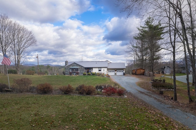 single story home with a garage and a front lawn