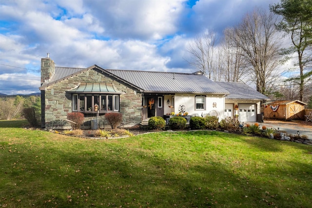 view of front of house featuring a garage and a front lawn