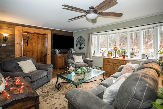 living room with wood walls, a healthy amount of sunlight, wood-type flooring, and crown molding