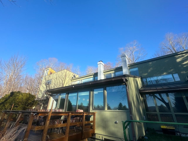 back of house with a sunroom