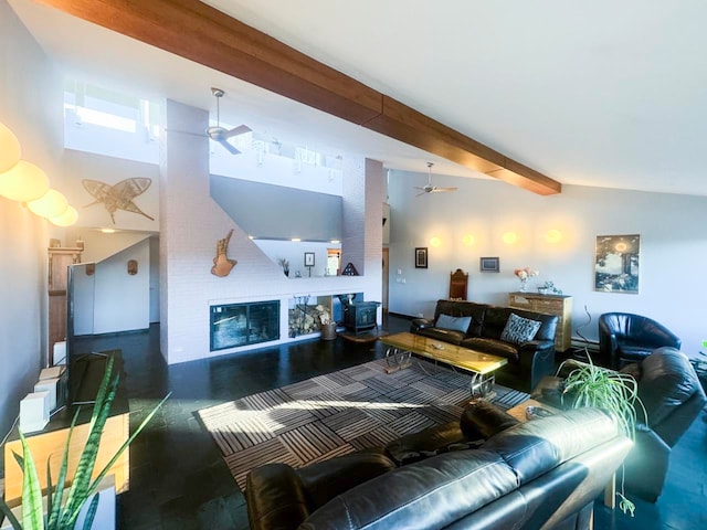 living room with beam ceiling, a wood stove, ceiling fan, and high vaulted ceiling