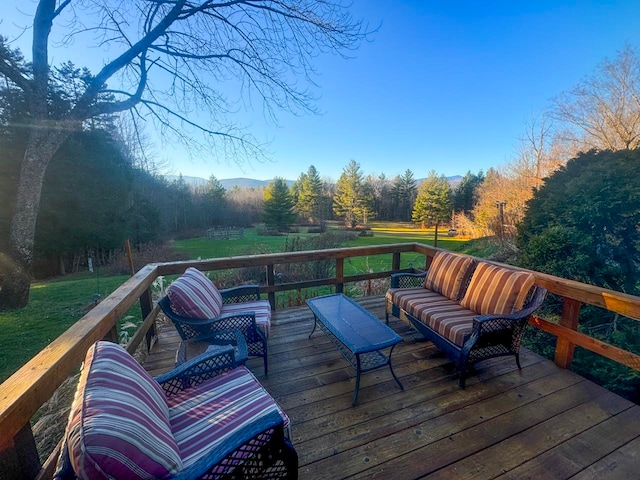 wooden terrace featuring a lawn and an outdoor living space