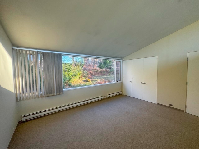 unfurnished bedroom featuring lofted ceiling, carpet floors, and a baseboard heating unit