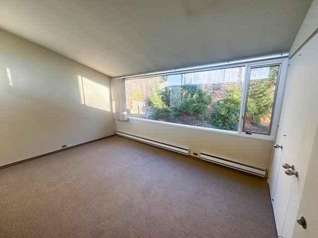 carpeted empty room with a baseboard radiator