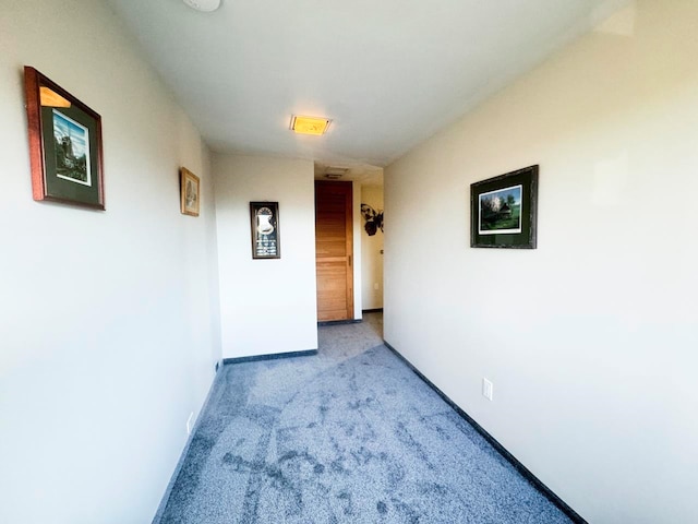 hallway featuring light colored carpet