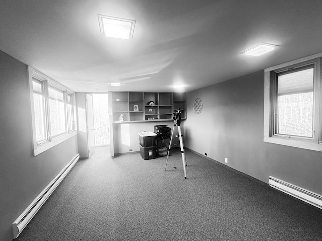 workout room featuring carpet and baseboard heating