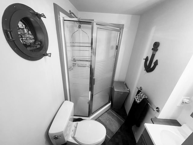 bathroom featuring vanity, toilet, and walk in shower