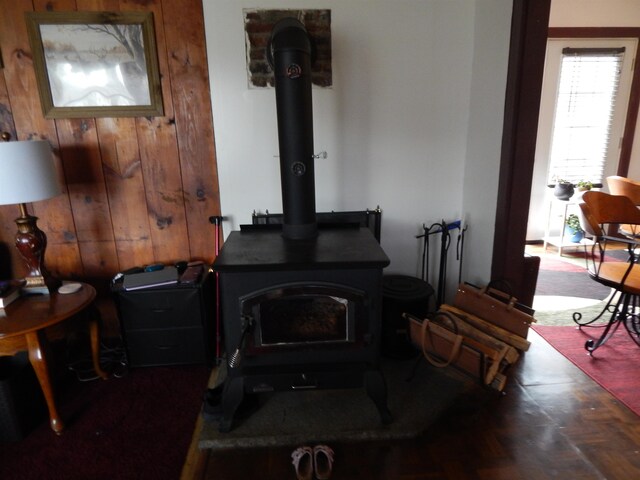 room details featuring a wood stove and wooden walls