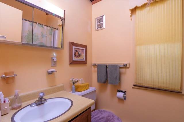 bathroom with vanity and toilet