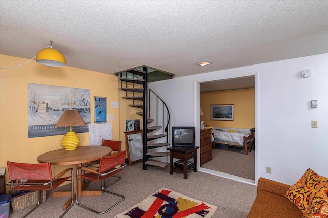 dining room with light carpet and a textured ceiling