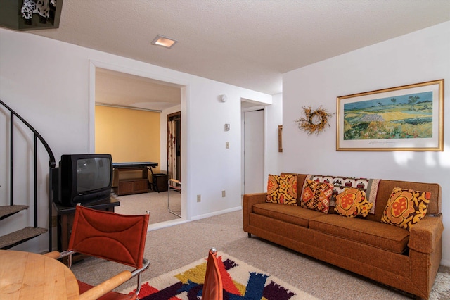 carpeted living room with a textured ceiling