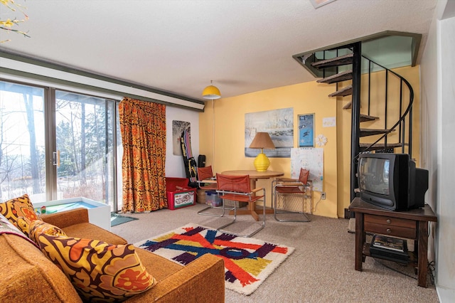 living room with carpet flooring and a textured ceiling