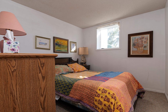 bedroom featuring carpet and a textured ceiling