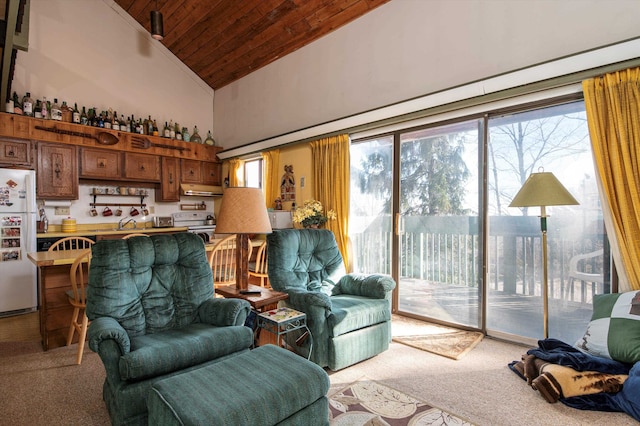 living room with high vaulted ceiling, a healthy amount of sunlight, carpet floors, and wood ceiling