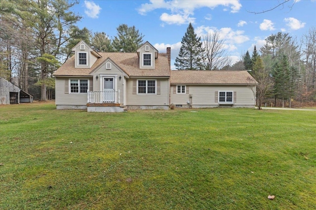 cape cod-style house featuring a front lawn