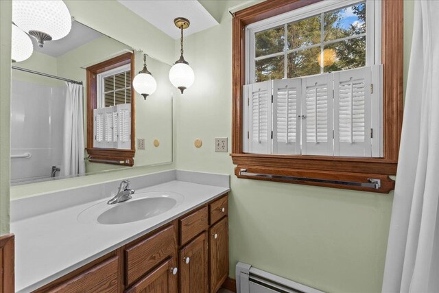 bathroom featuring a shower with shower curtain, vanity, and a baseboard radiator