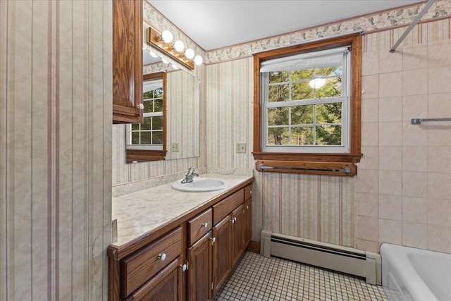 bathroom with a bath, tile patterned flooring, vanity, and a baseboard radiator