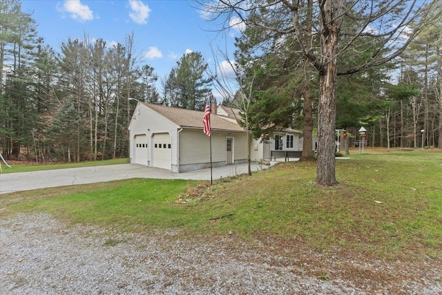 view of front of home with a garage and a front lawn