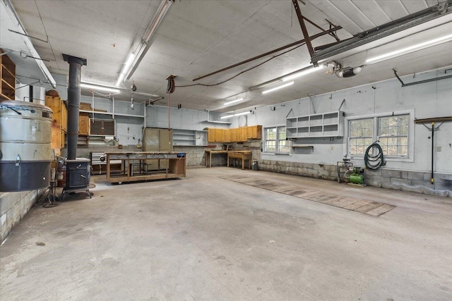 garage with a workshop area and a wood stove