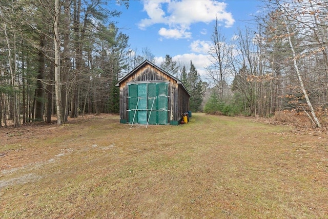 view of outbuilding featuring a lawn