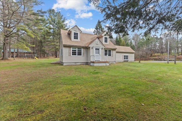 cape cod-style house with a playground and a front lawn