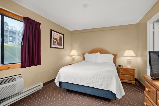 bedroom featuring dark colored carpet and a baseboard heating unit