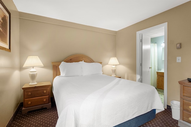 carpeted bedroom featuring ensuite bathroom