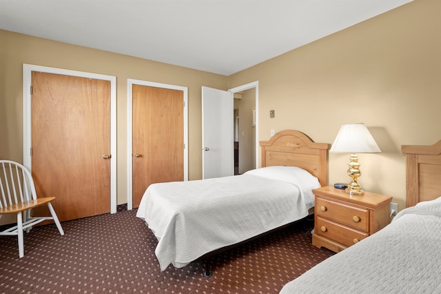 bedroom featuring dark carpet