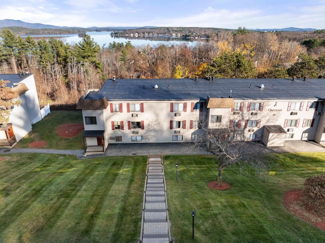 rear view of property with a water and mountain view