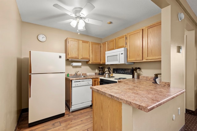 kitchen with ceiling fan, kitchen peninsula, light hardwood / wood-style floors, white appliances, and light brown cabinetry