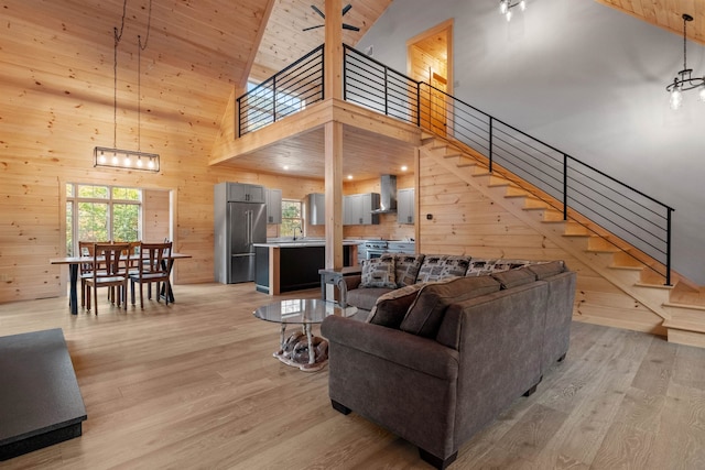 4 Hay Hill Rd, Lincoln, NH 03251 - living area with wood walls, light wood-type flooring, high vaulted ceiling, stairway, and wood ceiling