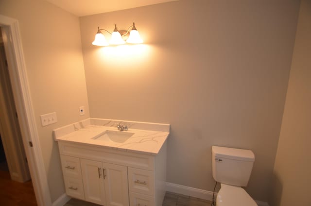 bathroom featuring vanity and toilet