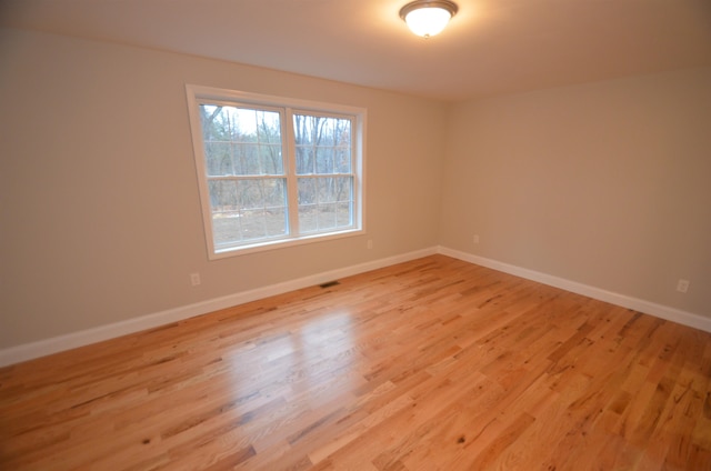 spare room featuring light hardwood / wood-style flooring