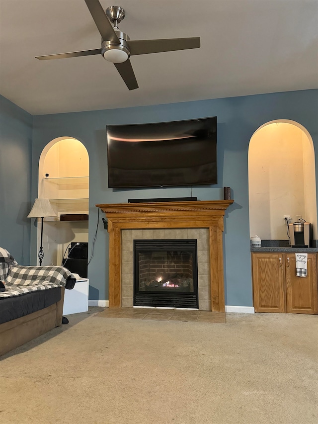 carpeted bedroom featuring a fireplace and ceiling fan