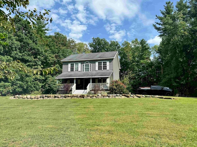 view of front of house with covered porch and a front yard