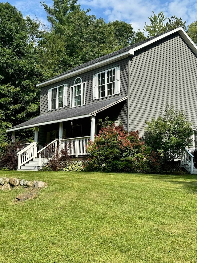 view of front of house with covered porch and a front yard