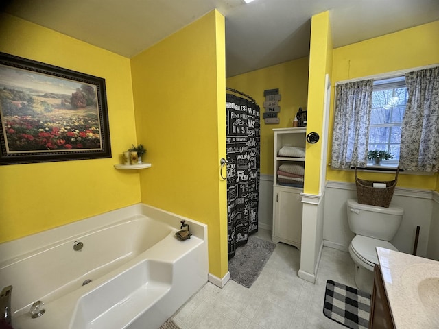 bathroom featuring a bathtub, toilet, and vanity