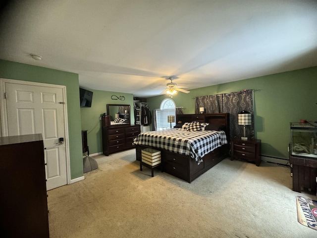 bedroom featuring ceiling fan, light colored carpet, and a baseboard radiator