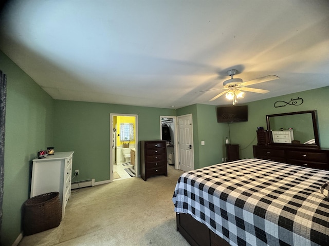 carpeted bedroom featuring ceiling fan, a closet, connected bathroom, and a baseboard heating unit