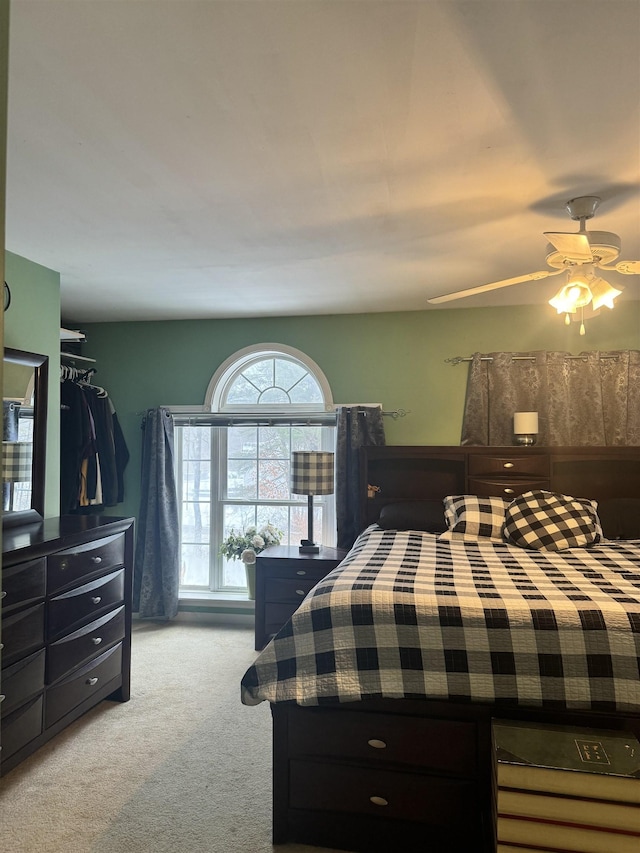 bedroom featuring light carpet and ceiling fan