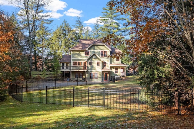 view of front facade featuring a wooden deck and a front yard