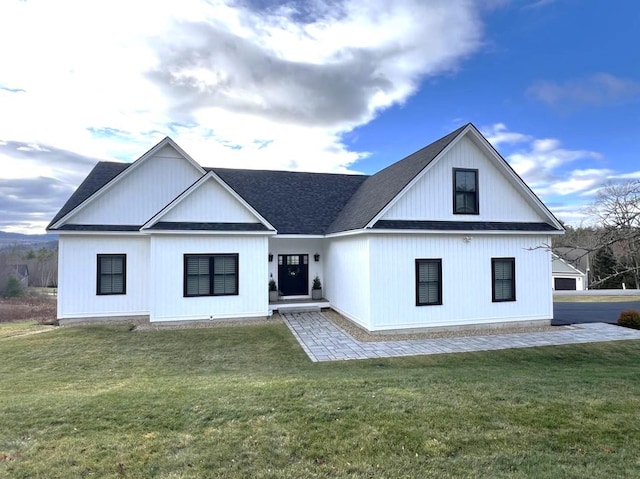 modern farmhouse style home with a front lawn