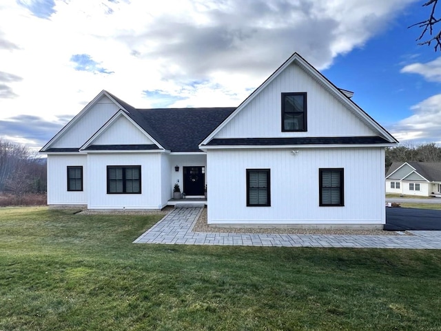 rear view of house featuring a yard