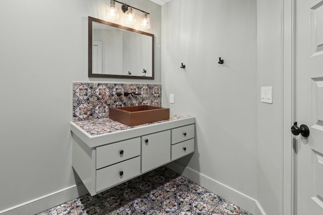 bathroom featuring tile patterned floors, vanity, and decorative backsplash