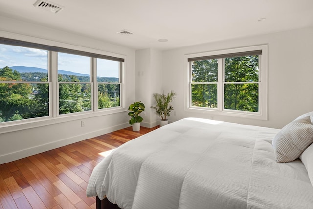 bedroom featuring a mountain view and hardwood / wood-style floors